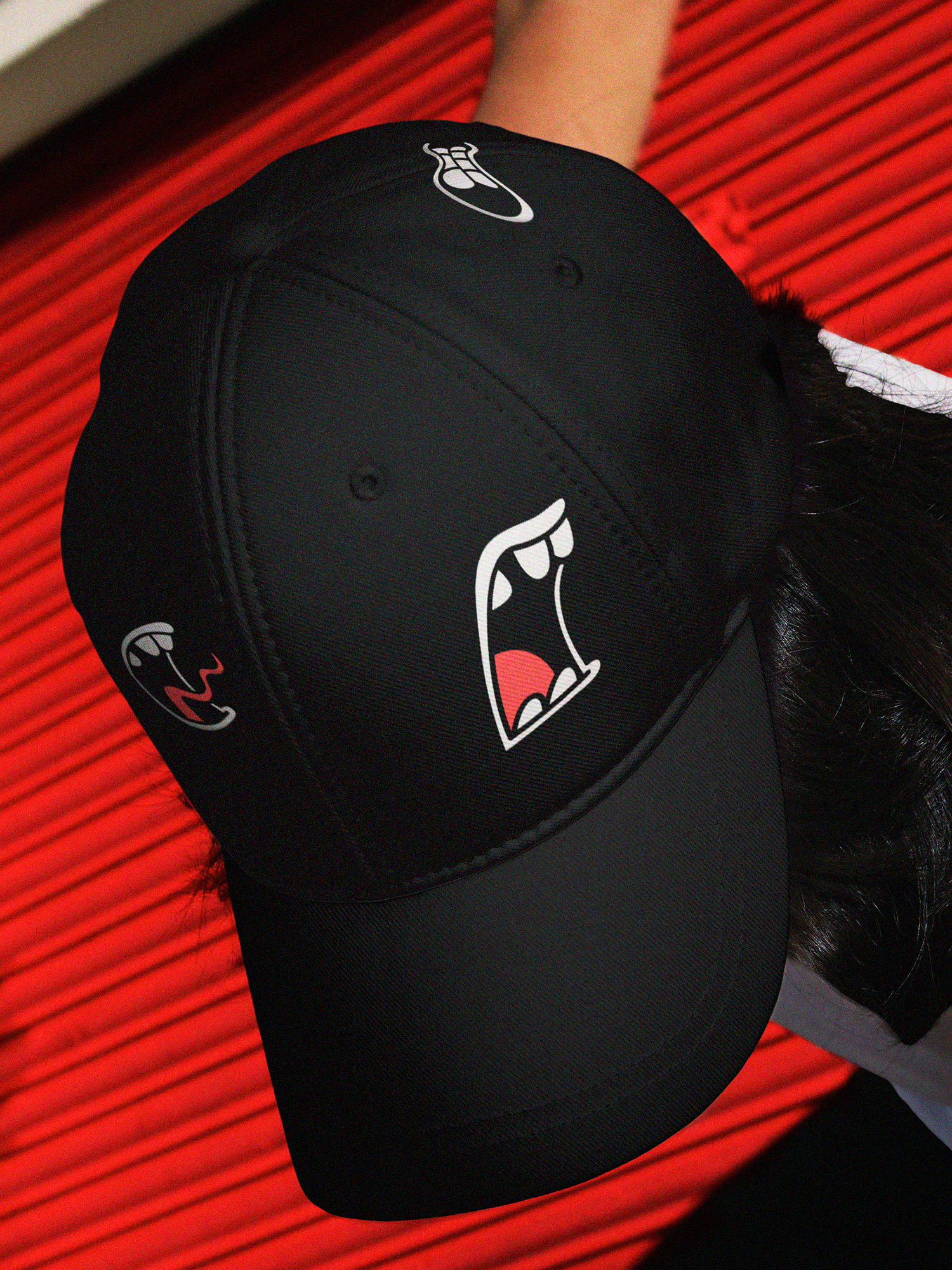 A black hat with Bite Back mouths printed in top