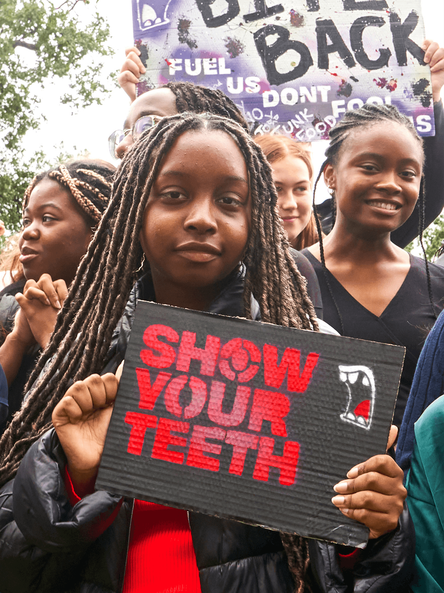 Bite Back Activist holding up a hand-made placard