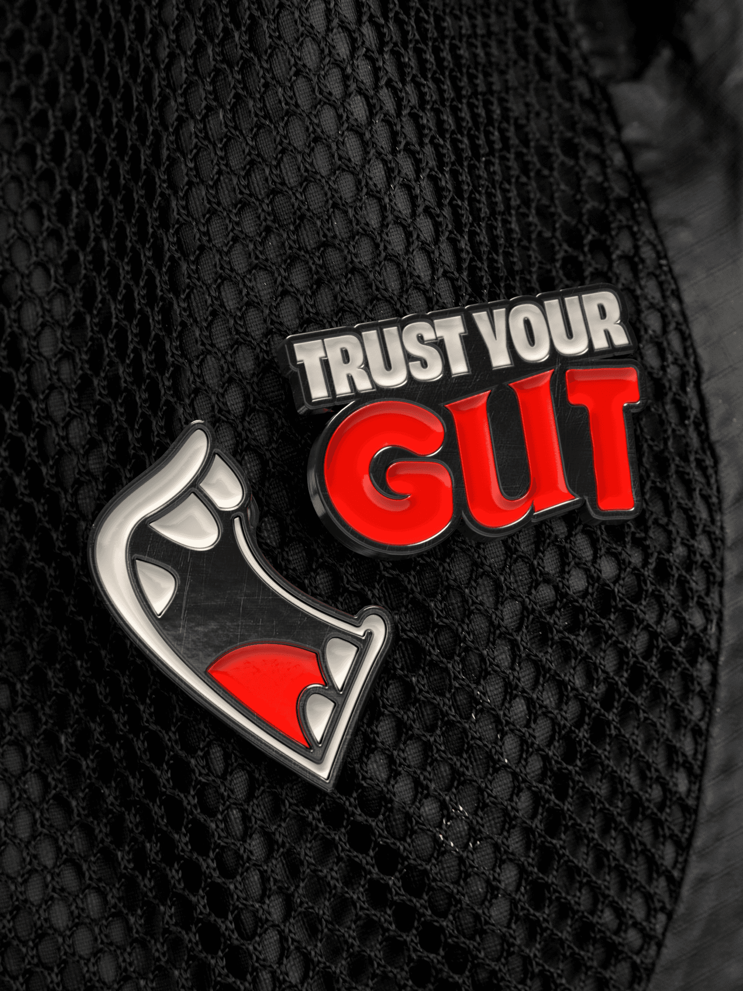 Bite Back pins attached to a backpack